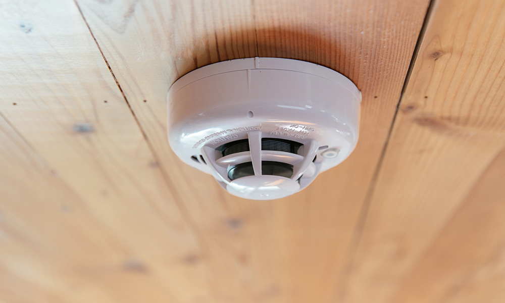 smoke detector wood ceiling closeup